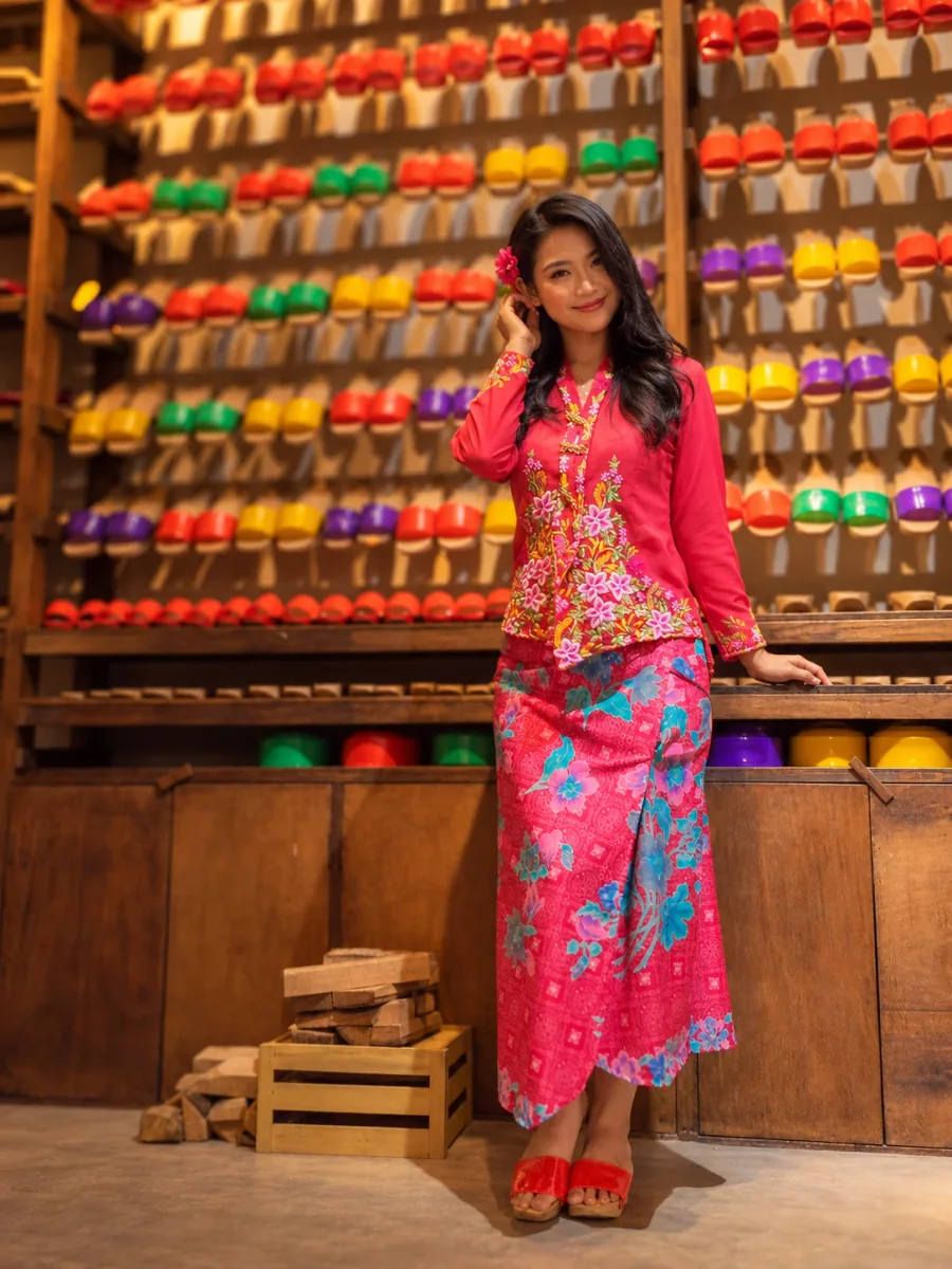 A kebaya portrait beside the wooden clog display
